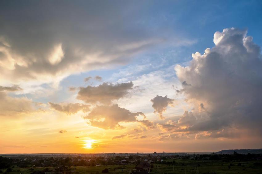 Dramatic sunset landscape with puffy clouds lit by 2024 12 06 01 32 15 utc