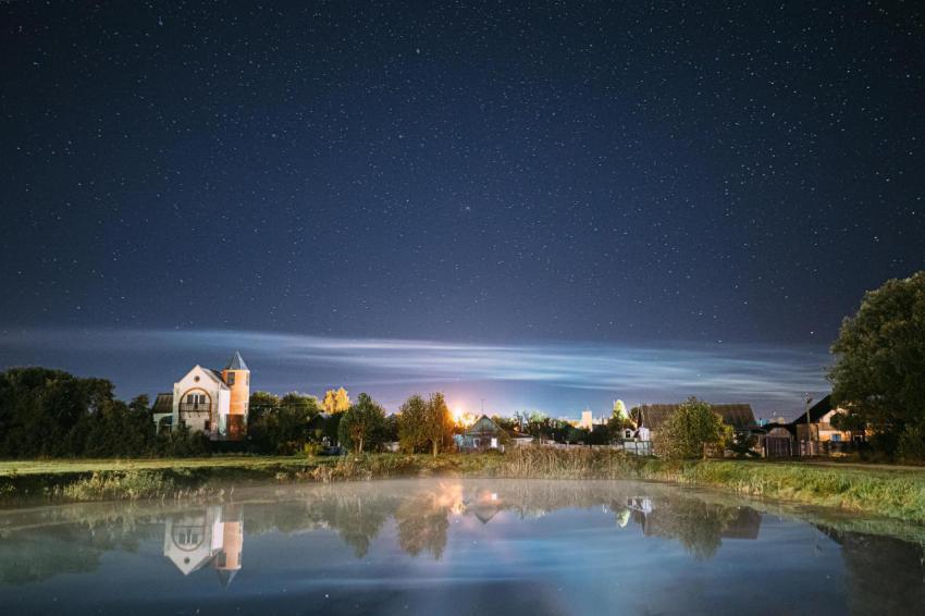 Night clouds over river lake near houses in villag 2023 11 27 05 22 03 utc